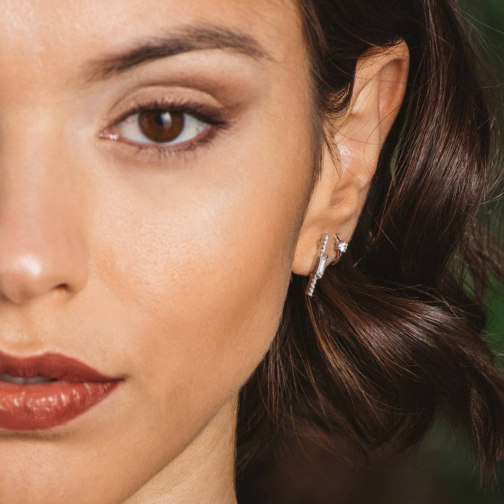Silver and zircon earrings in a row