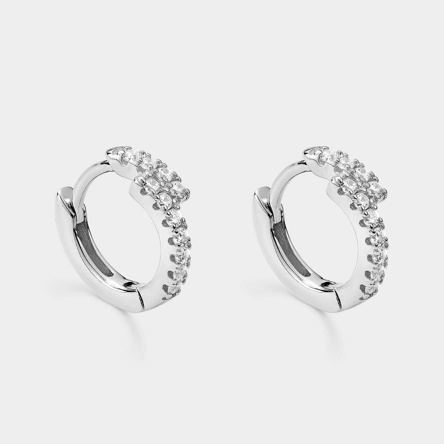 Creole silver earrings with two lanes of white zigzag zircons.