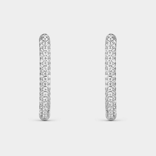 Pendientes criollas de plata con forma oval con  circonitas blancas en la mitad de su elipse.