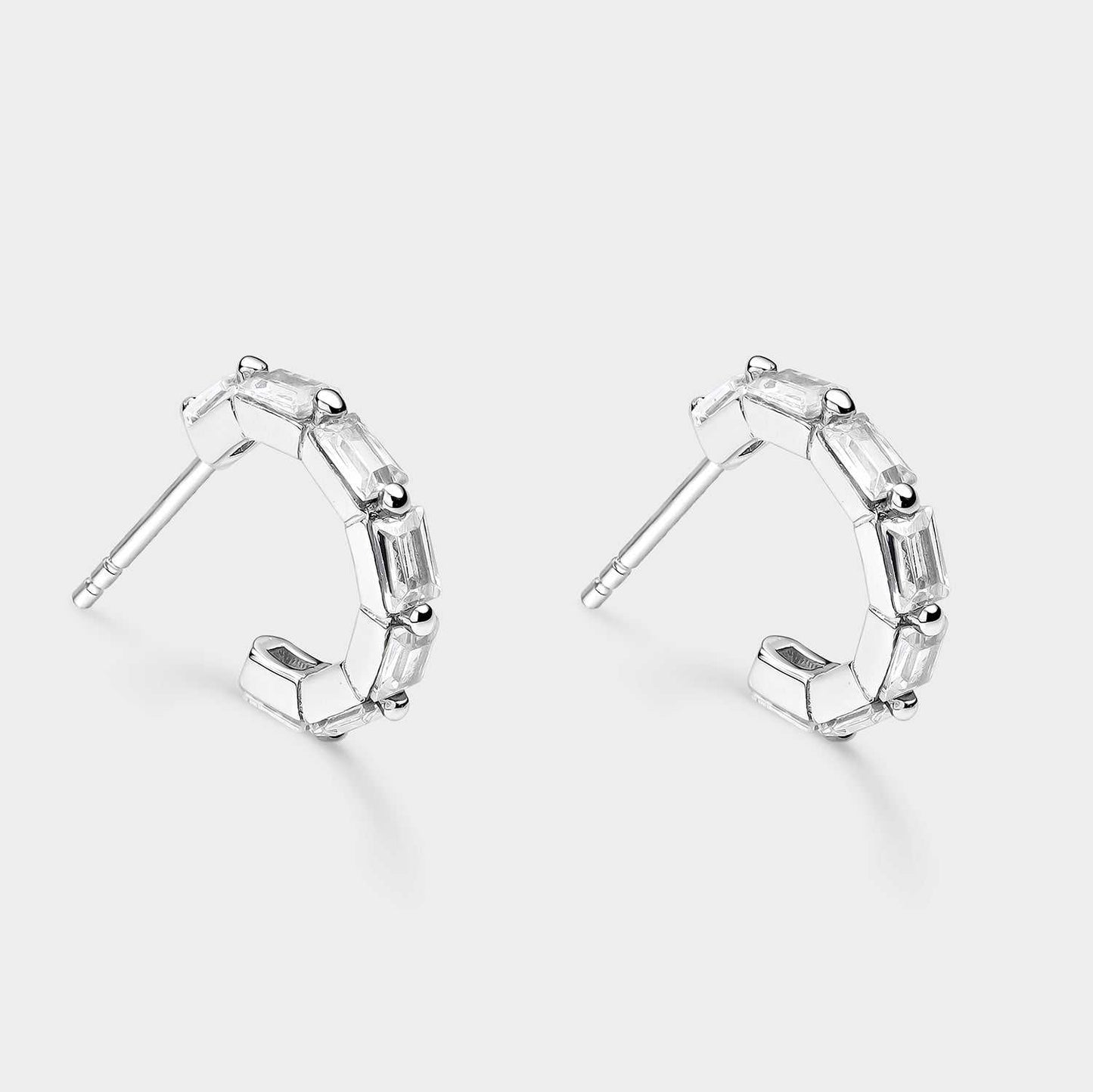 Open silver Creole earrings with rectangular white zircons