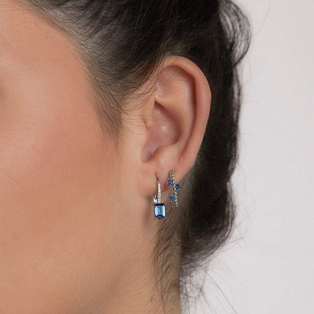 Silver hoop earrings with blue zircons