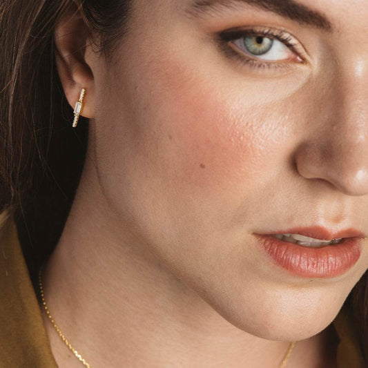 Silver and zircon earrings in a row