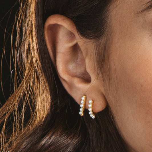 Silver and gold earrings with elongated pearls