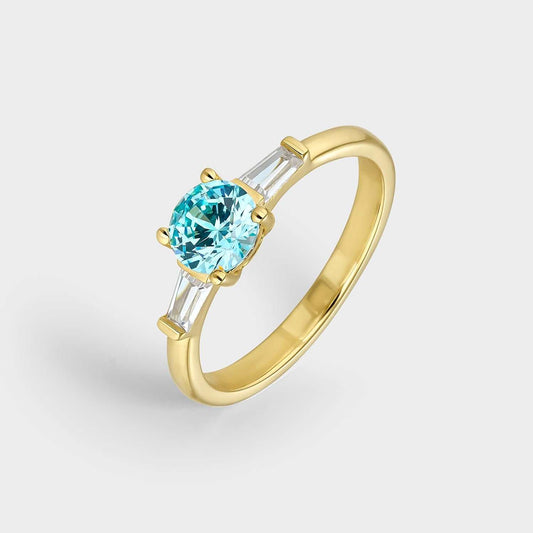 Anillo trío de plata con baño de oro 18k con circonita azul aguamarina