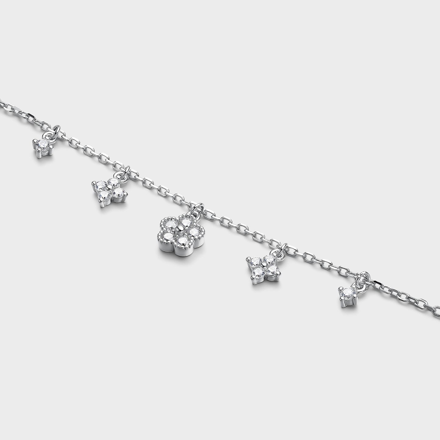 Pulsera de plata y flores colgantes con circonitas