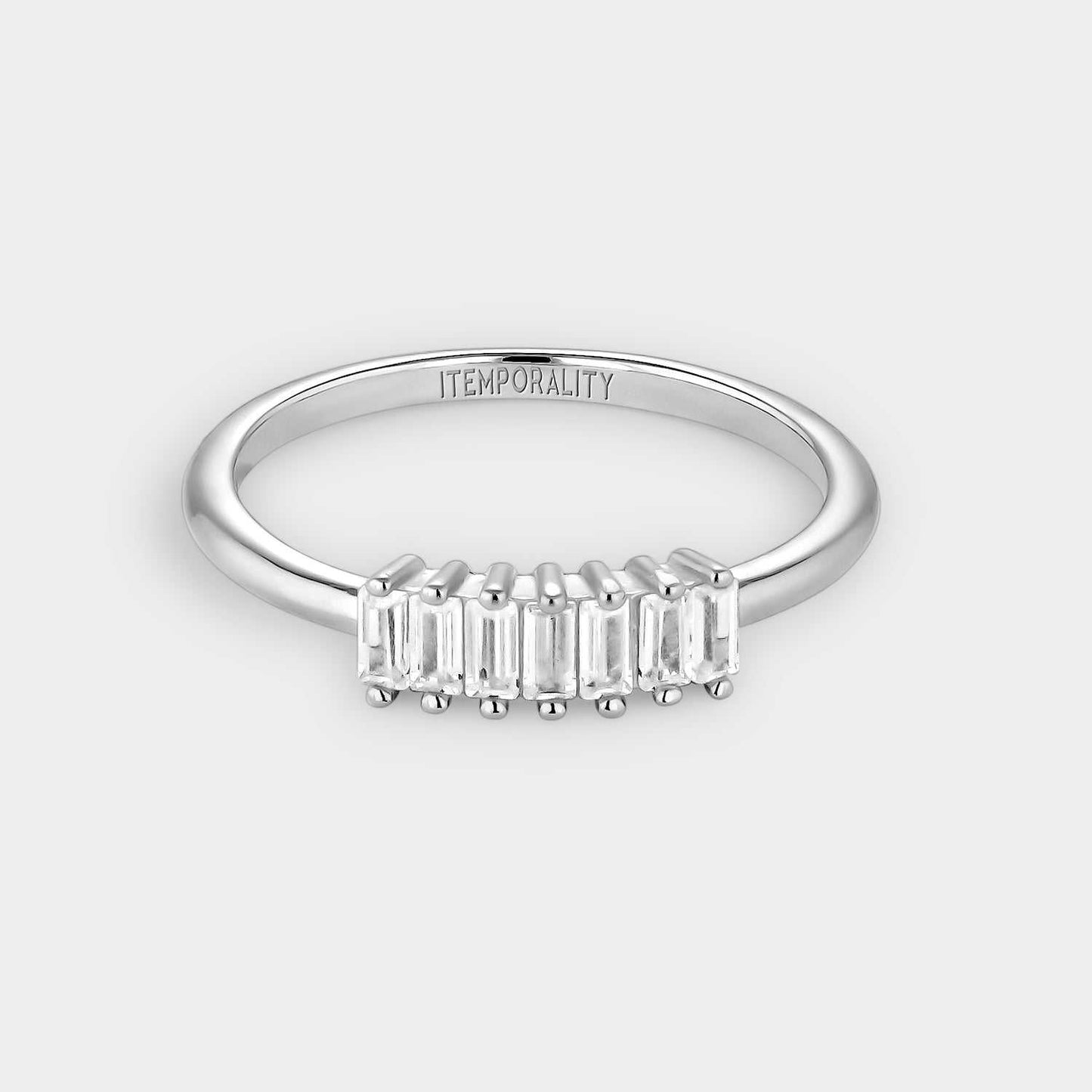 Silver ring with white rectangular zircons.