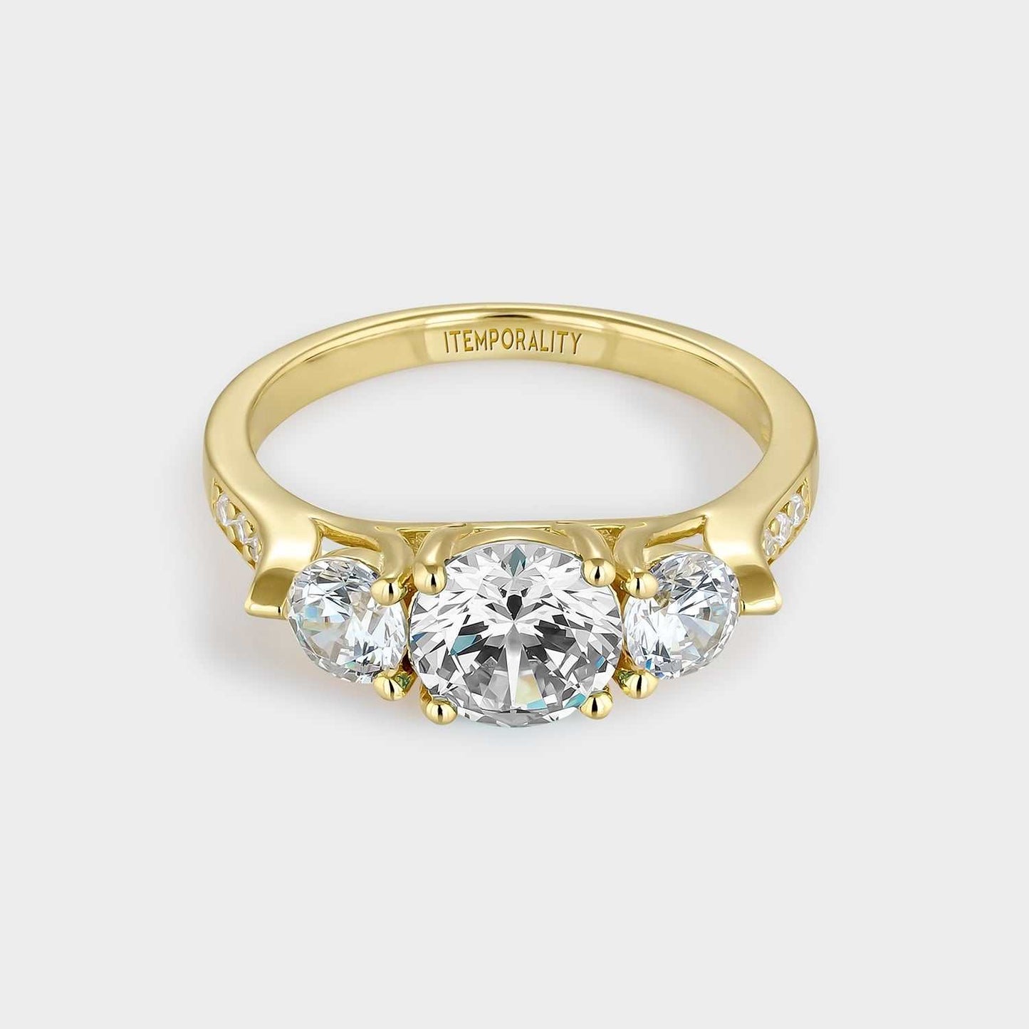 Yellow gold plated silver ring with three white zircons